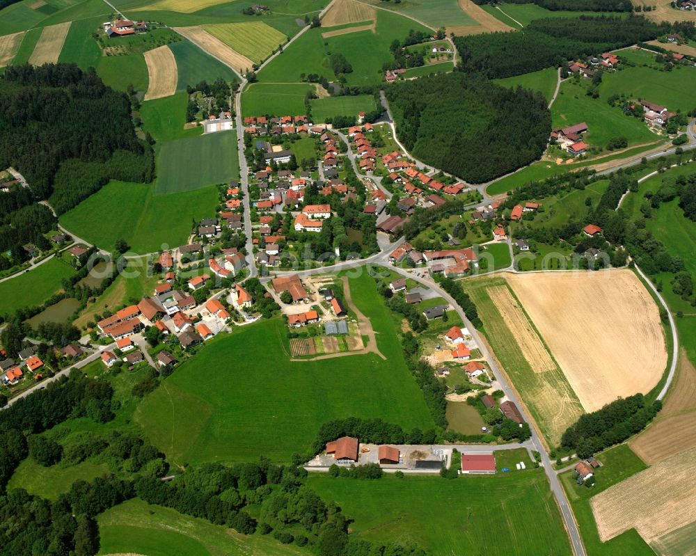 Haselbach from above - Agricultural land and field boundaries surround the settlement area of the village in Haselbach in the state Bavaria, Germany