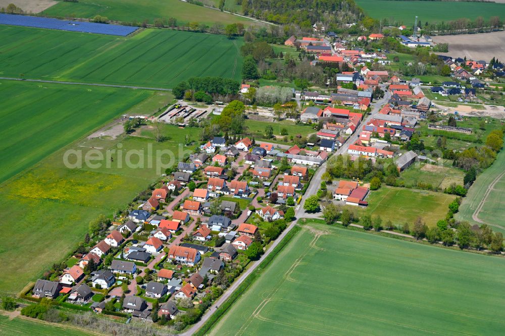 Hassel from the bird's eye view: Agricultural land and field boundaries surround the settlement area of the village in Hassel in the state Saxony-Anhalt, Germany