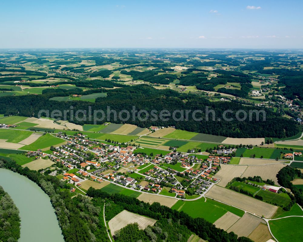 Haunreit from above - Agricultural land and field boundaries surround the settlement area of the village in Haunreit in the state Bavaria, Germany