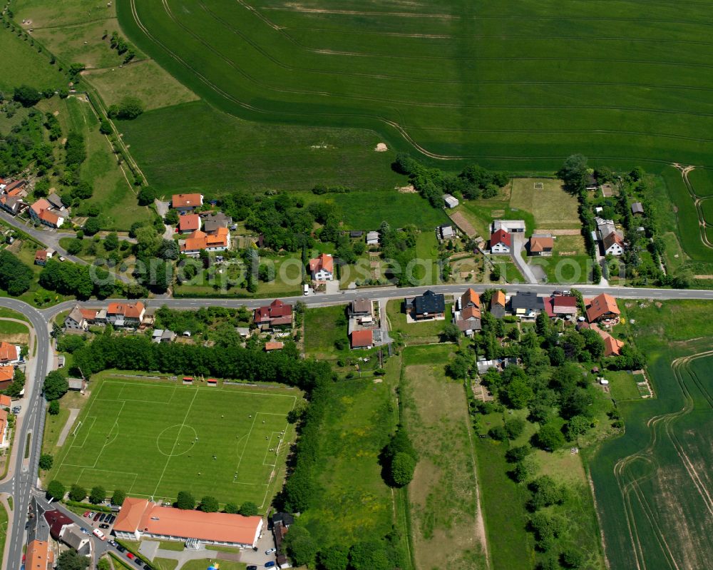 Hauröden from the bird's eye view: Agricultural land and field boundaries surround the settlement area of the village in Hauröden in the state Thuringia, Germany