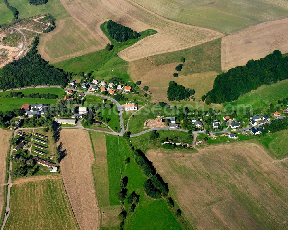 Hausdorf from above - Agricultural land and field boundaries surround the settlement area of the village in Hausdorf in the state Saxony, Germany