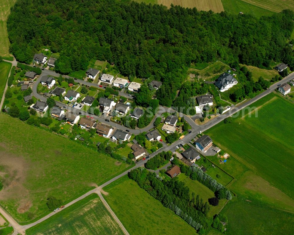 Aerial photograph Hausen - Agricultural land and field boundaries surround the settlement area of the village in Hausen in the state Hesse, Germany