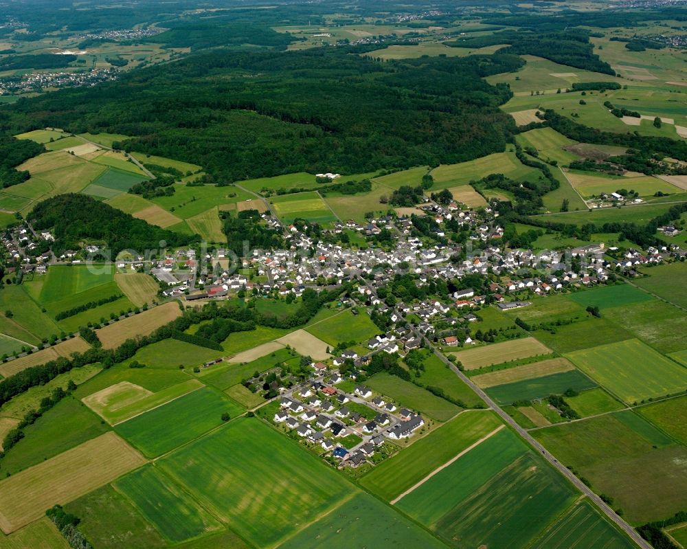 Hausen from the bird's eye view: Agricultural land and field boundaries surround the settlement area of the village in Hausen in the state Hesse, Germany