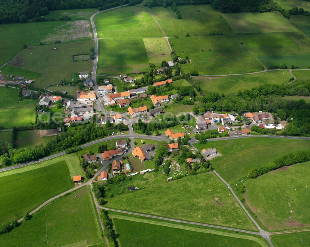 Heisters from above - Agricultural land and field boundaries surround the settlement area of the village in Heisters in the state Hesse, Germany