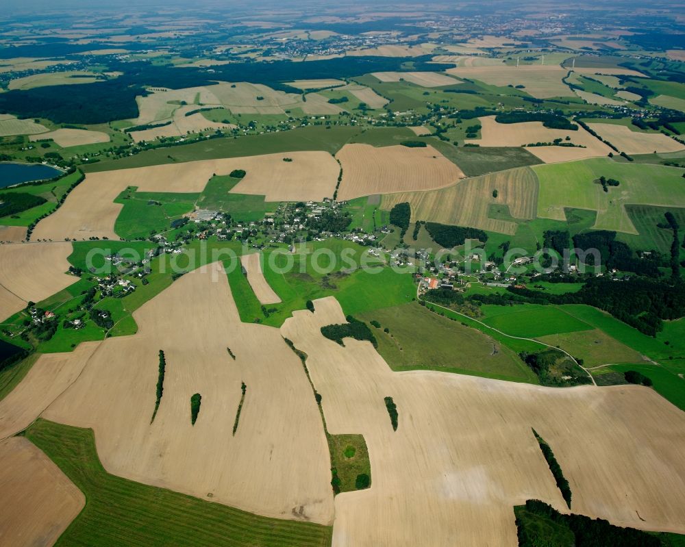 Helbigsdorf from above - Agricultural land and field boundaries surround the settlement area of the village in Helbigsdorf in the state Saxony, Germany