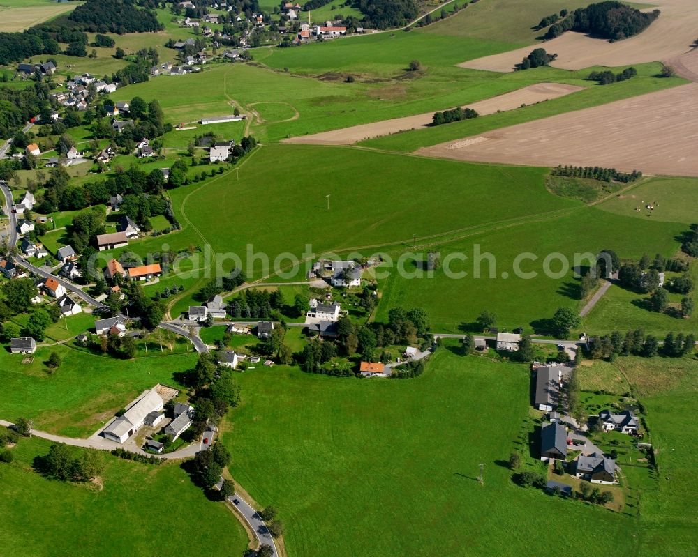 Helbigsdorf from above - Agricultural land and field boundaries surround the settlement area of the village in Helbigsdorf in the state Saxony, Germany