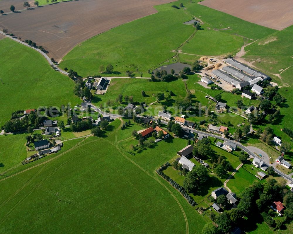 Helbigsdorf from above - Agricultural land and field boundaries surround the settlement area of the village in Helbigsdorf in the state Saxony, Germany