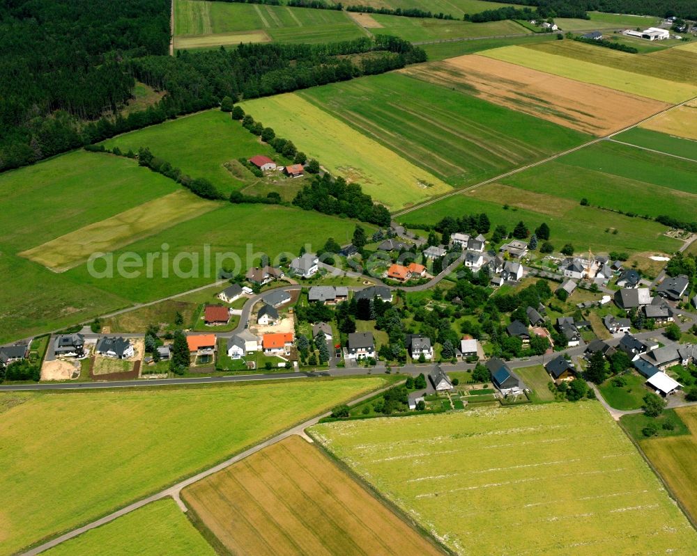 Hellertshausen from above - Agricultural land and field boundaries surround the settlement area of the village in Hellertshausen in the state Rhineland-Palatinate, Germany