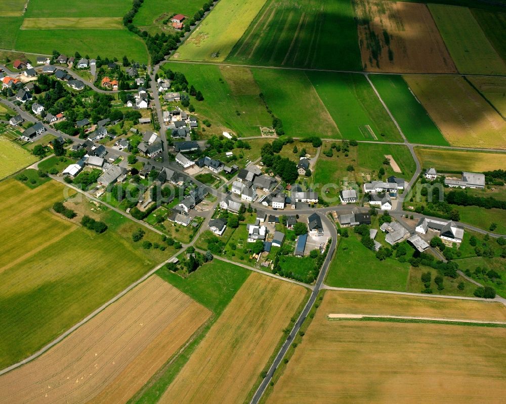 Hellertshausen from above - Agricultural land and field boundaries surround the settlement area of the village in Hellertshausen in the state Rhineland-Palatinate, Germany