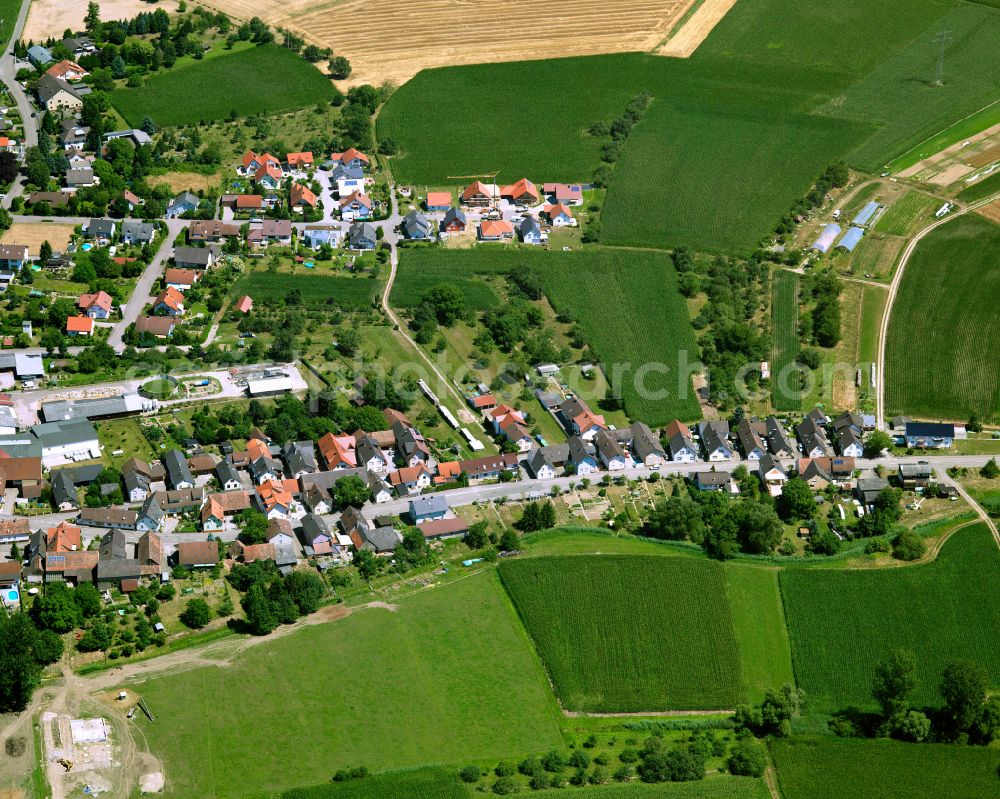 Helmlingen from the bird's eye view: Agricultural land and field boundaries surround the settlement area of the village in Helmlingen in the state Baden-Wuerttemberg, Germany