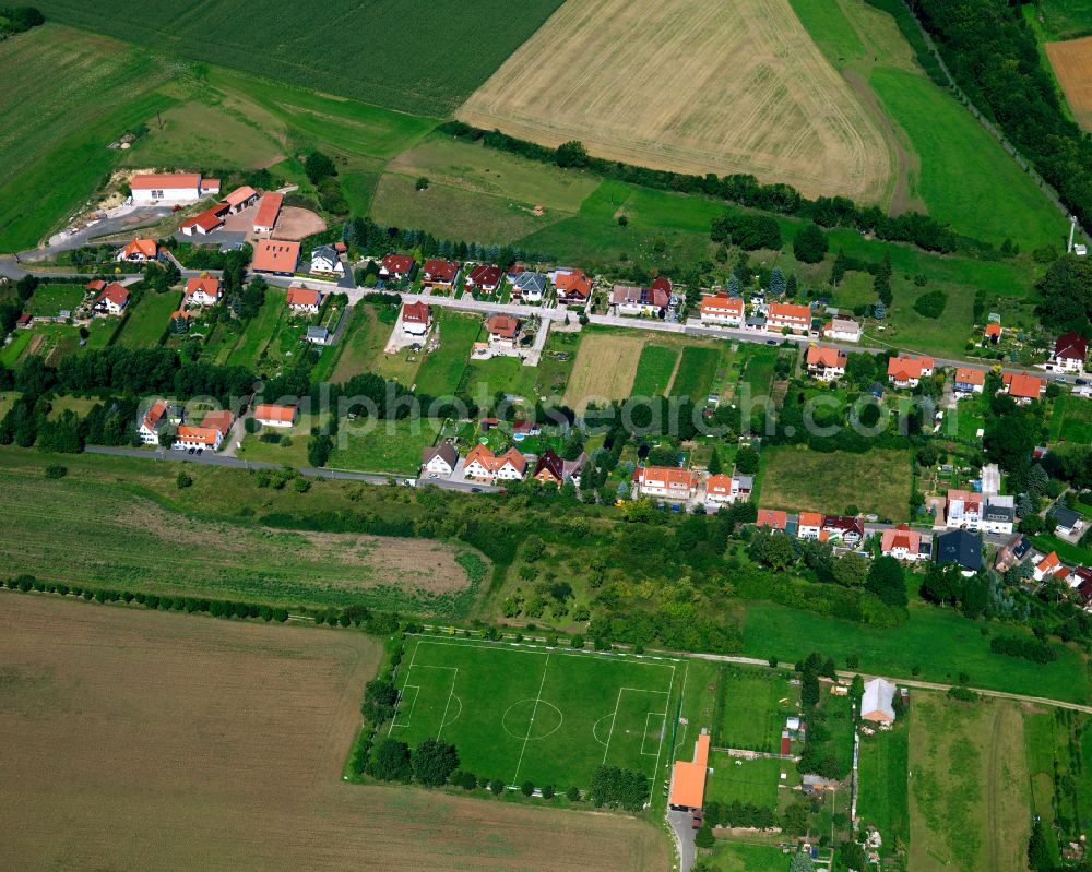 Helmsdorf from above - Agricultural land and field boundaries surround the settlement area of the village in Helmsdorf in the state Thuringia, Germany