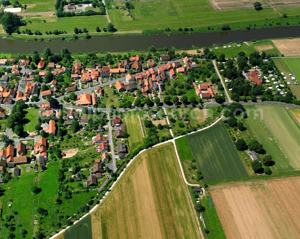 Hemeln from above - Agricultural land and field boundaries surround the settlement area of the village in Hemeln in the state Lower Saxony, Germany