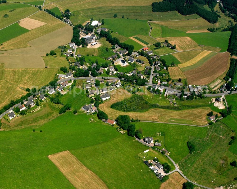 Hemschlar from above - Agricultural land and field boundaries surround the settlement area of the village in Hemschlar in the state North Rhine-Westphalia, Germany