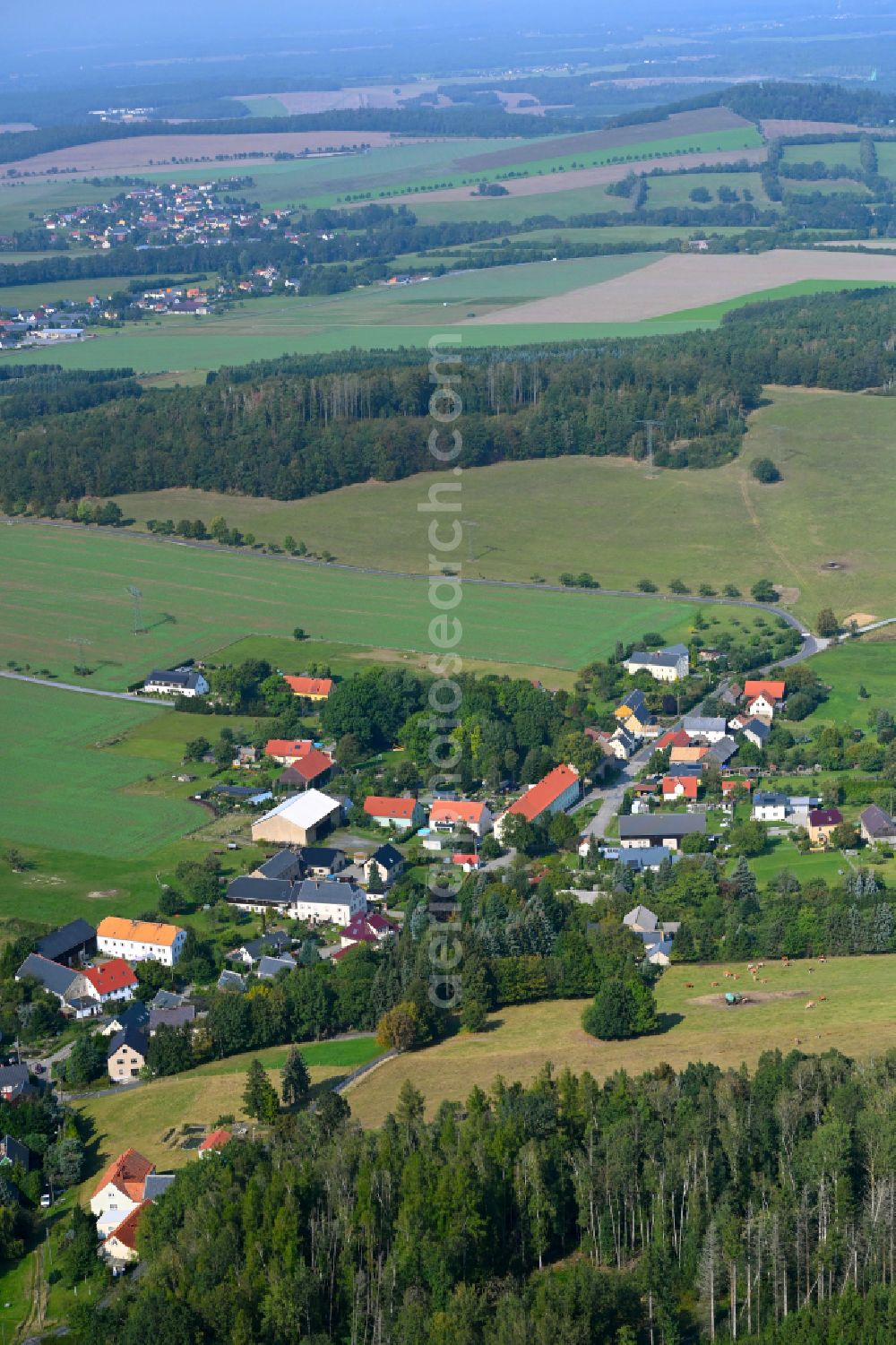 Hennersdorf from above - Agricultural land and field boundaries surround the settlement area of the village on street Dorfstrasse in Hennersdorf in the state Saxony, Germany