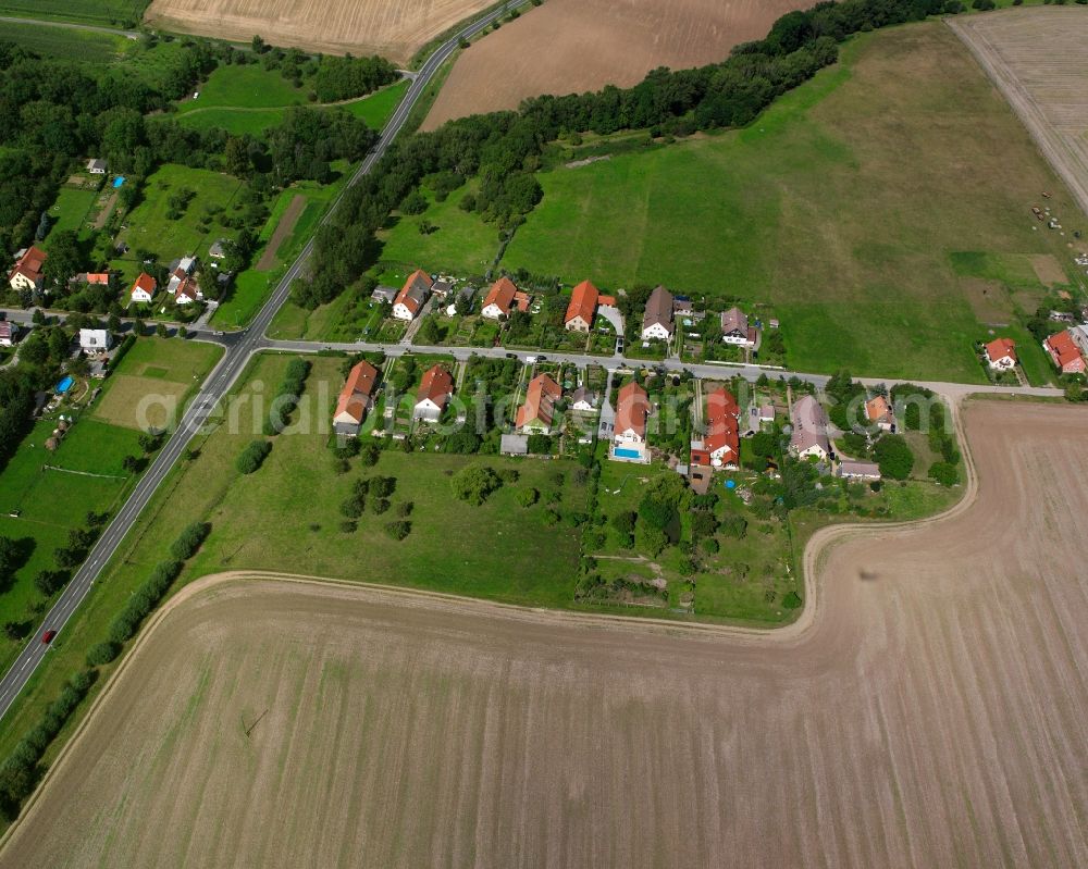 Henningsleben from above - Agricultural land and field boundaries surround the settlement area of the village in Henningsleben in the state Thuringia, Germany