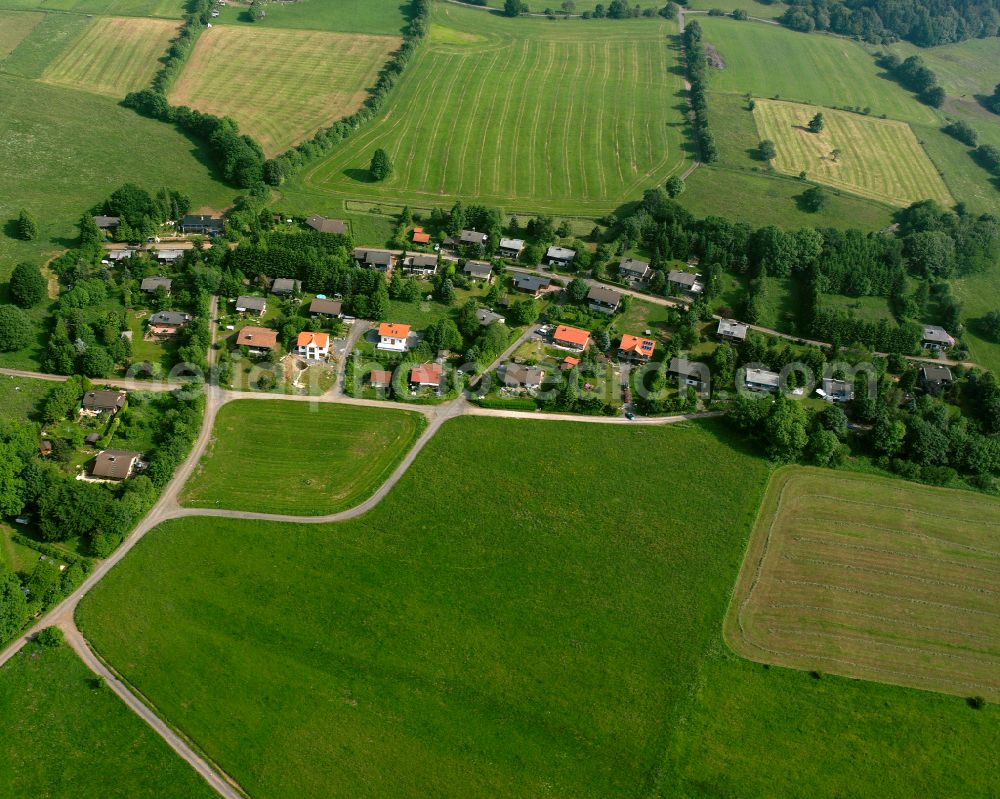 Aerial image Herchenhain - Agricultural land and field boundaries surround the settlement area of the village in Herchenhain in the state Hesse, Germany