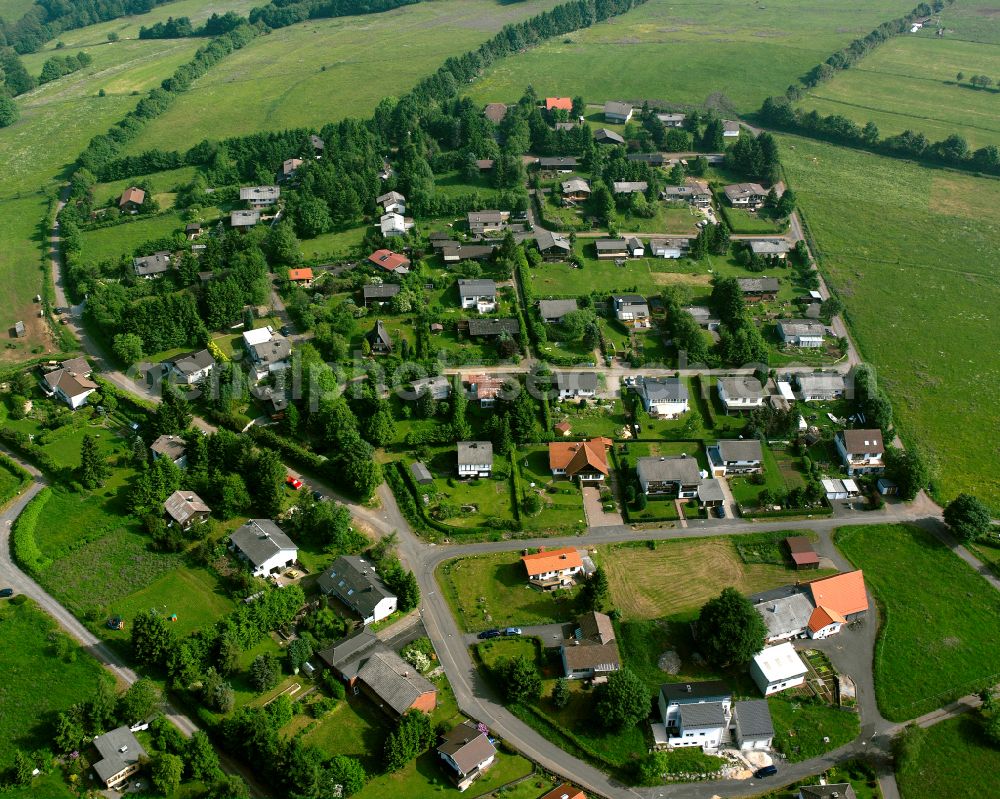 Aerial photograph Herchenhain - Agricultural land and field boundaries surround the settlement area of the village in Herchenhain in the state Hesse, Germany