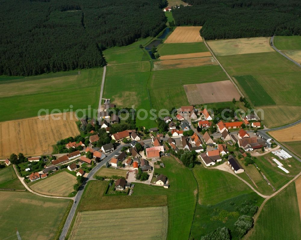 Hergersbach from above - Agricultural land and field boundaries surround the settlement area of the village in Hergersbach in the state Bavaria, Germany