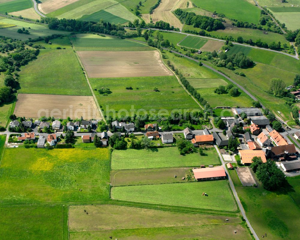 Aerial photograph Hergersdorf - Agricultural land and field boundaries surround the settlement area of the village in Hergersdorf in the state Hesse, Germany