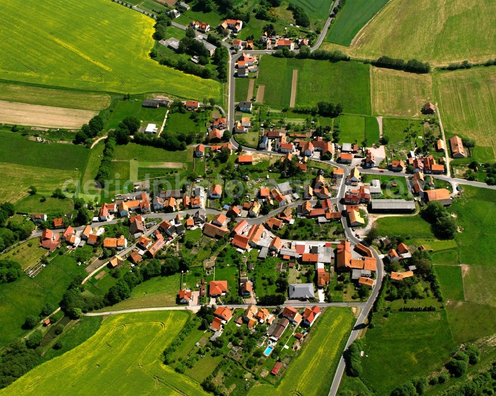 Heringen (Werra) from above - Agricultural land and field boundaries surround the settlement area of the village in Heringen (Werra) in the state Thuringia, Germany