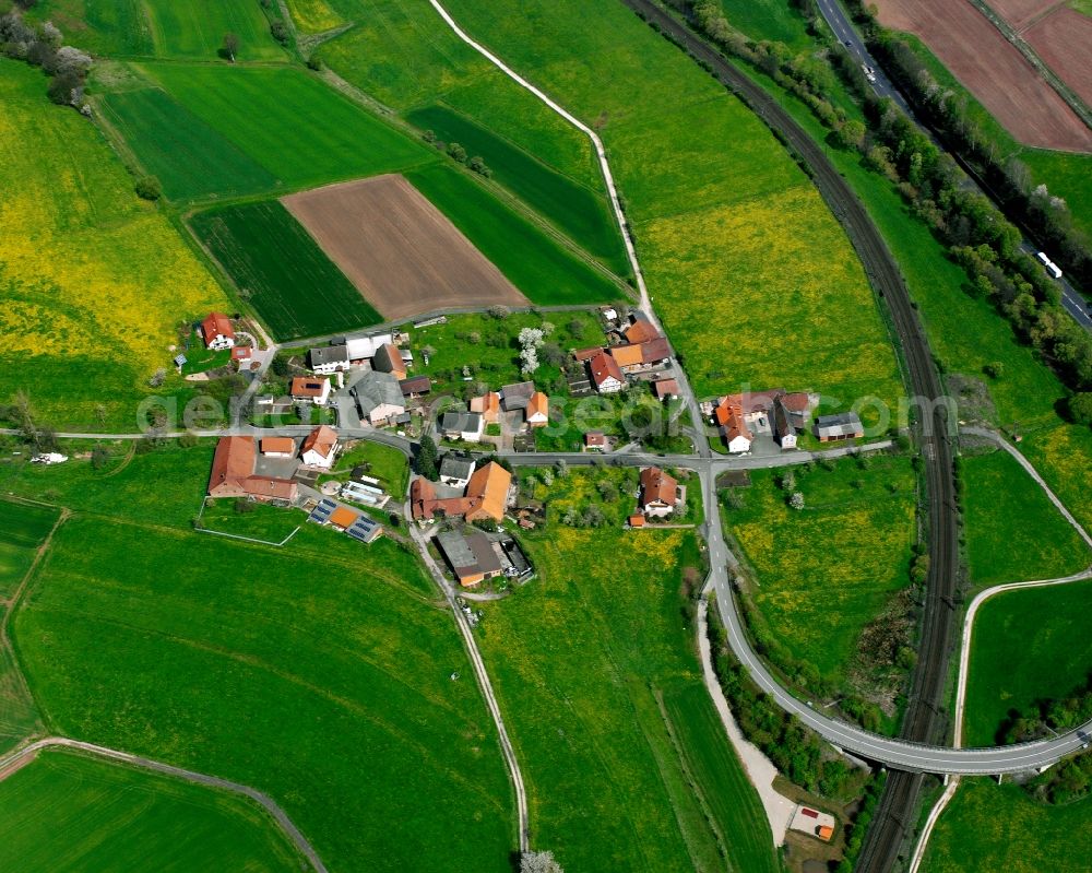 Hermannspiegel from above - Agricultural land and field boundaries surround the settlement area of the village in Hermannspiegel in the state Hesse, Germany