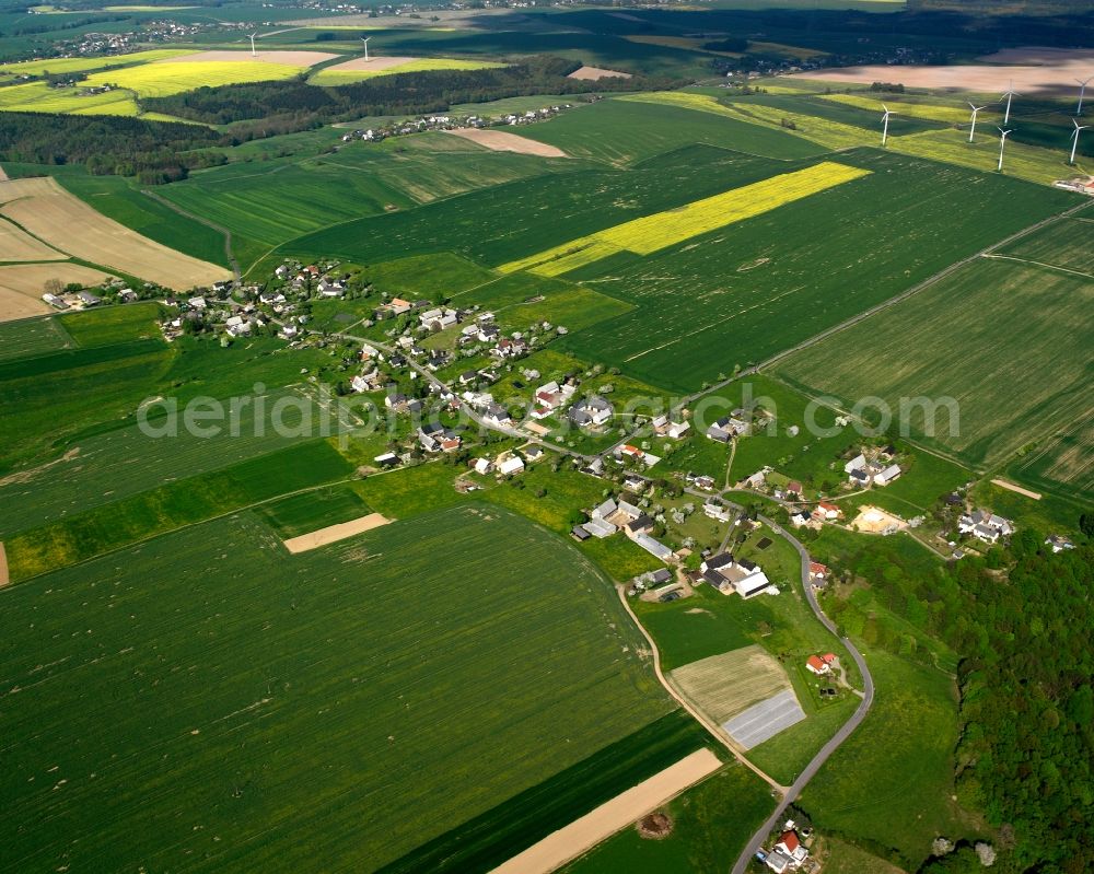 Hermsdorf from the bird's eye view: Agricultural land and field boundaries surround the settlement area of the village in Hermsdorf in the state Saxony, Germany