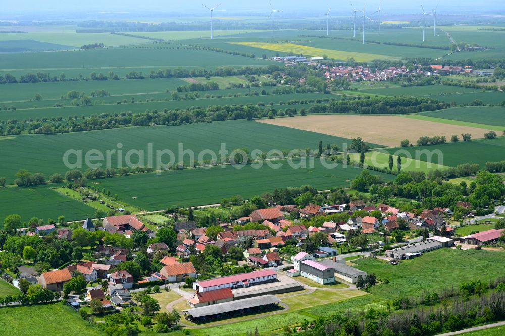 Herrnschwende from above - Agricultural land and field boundaries surround the settlement area of the village in Herrnschwende in the state Thuringia, Germany