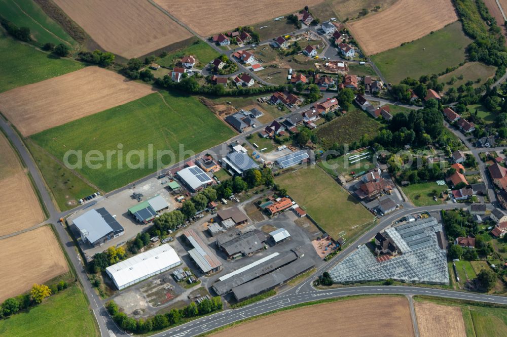 Heßdorf from above - Agricultural land and field boundaries surround the settlement area of the village in Heßdorf in the state Bavaria, Germany