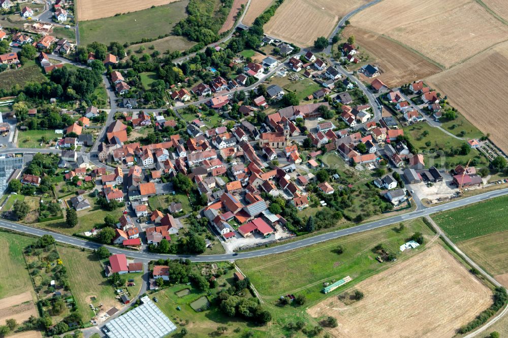 Heßdorf from the bird's eye view: Agricultural land and field boundaries surround the settlement area of the village in Heßdorf in the state Bavaria, Germany