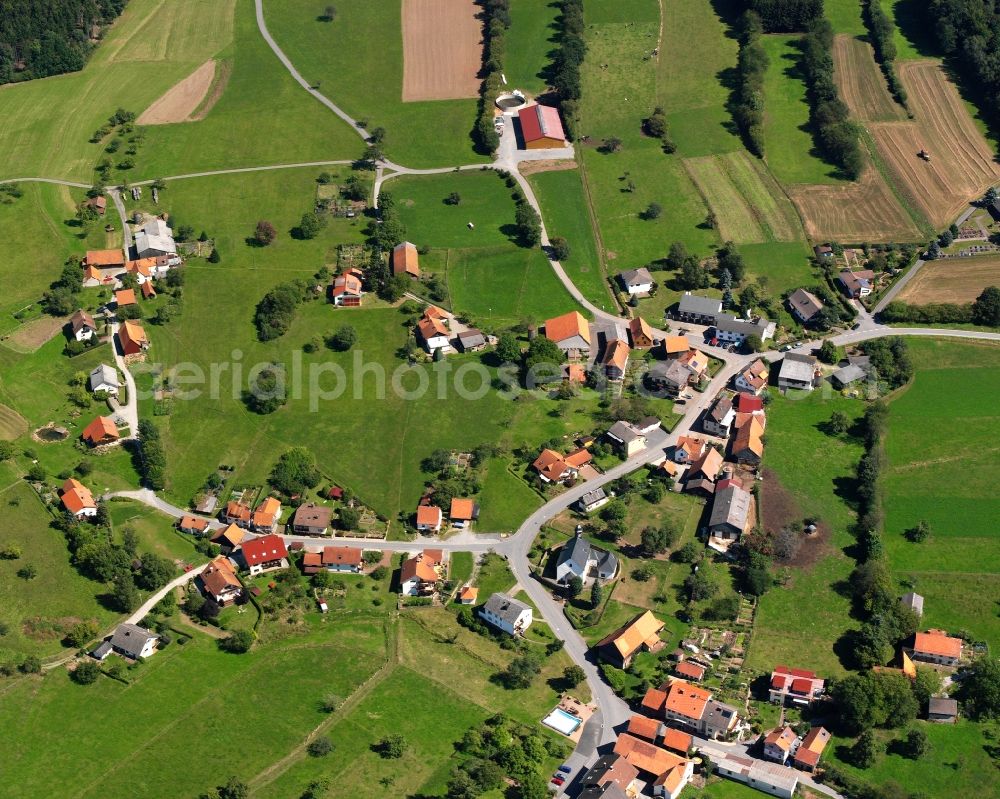 Hesselbach from above - Agricultural land and field boundaries surround the settlement area of the village in Hesselbach in the state Hesse, Germany