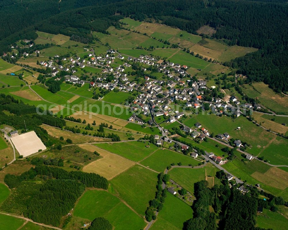 Hesselbach from the bird's eye view: Agricultural land and field boundaries surround the settlement area of the village in Hesselbach at Siegerland in the state North Rhine-Westphalia, Germany