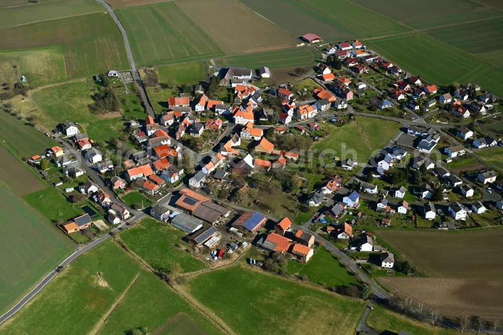 Heßlar from the bird's eye view: Agricultural land and field boundaries surround the settlement area of the village in Heßlar in the state Hesse, Germany