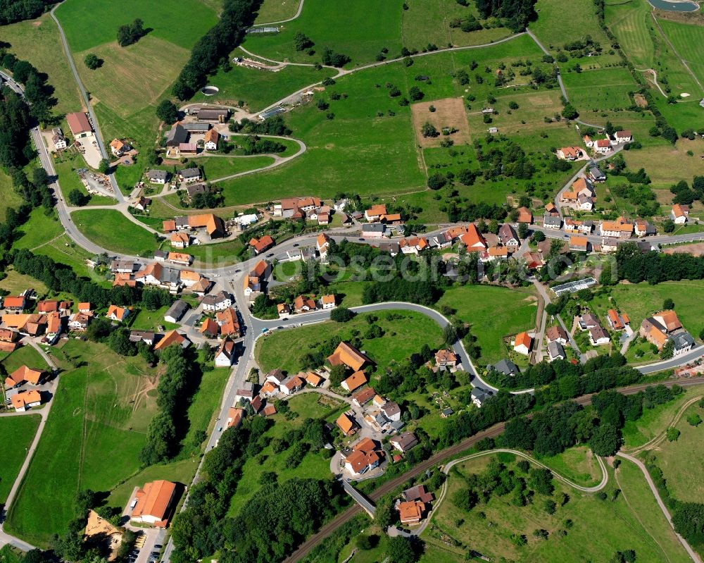 Aerial image Hetzbach - Agricultural land and field boundaries surround the settlement area of the village in Hetzbach in the state Hesse, Germany