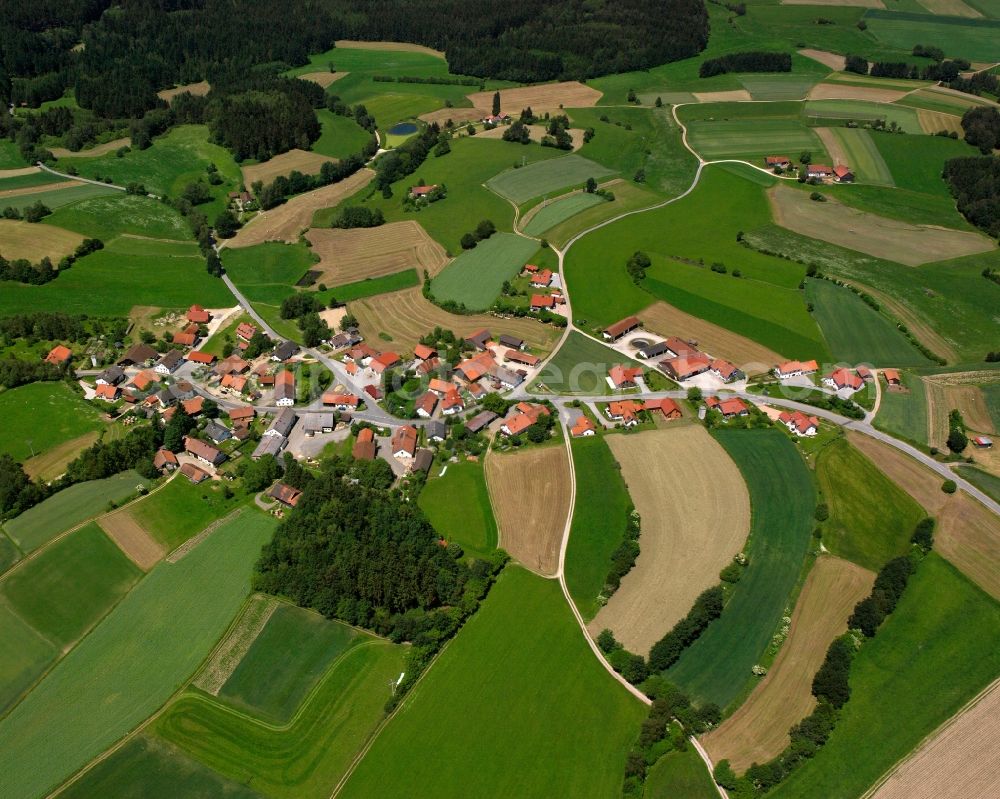 Höhenberg from above - Agricultural land and field boundaries surround the settlement area of the village in Höhenberg in the state Bavaria, Germany