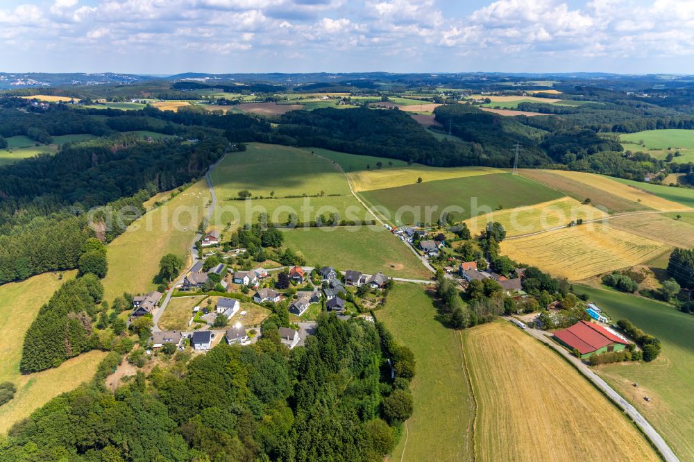 Hillringhausen from above - Agricultural land and field boundaries surround the settlement area of the village in Hillringhausen in the state North Rhine-Westphalia, Germany