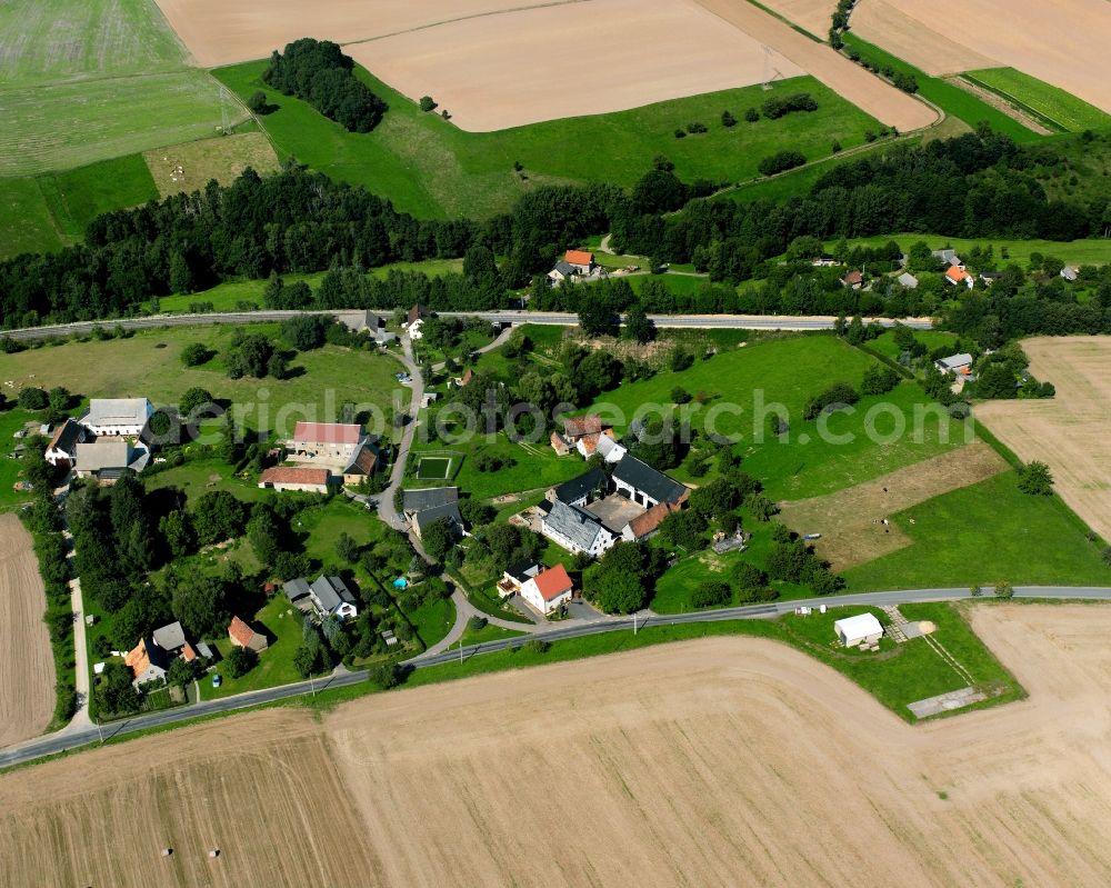 Himmelhartha from above - Agricultural land and field boundaries surround the settlement area of the village in Himmelhartha in the state Saxony, Germany