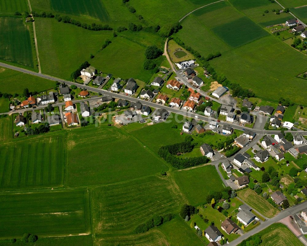 Aerial image Hintermeilingen - Agricultural land and field boundaries surround the settlement area of the village in Hintermeilingen in the state Hesse, Germany