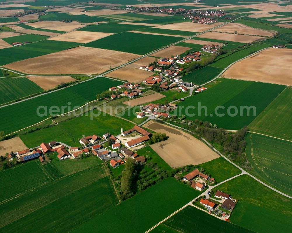 Hirschkofen from above - Agricultural land and field boundaries surround the settlement area of the village in Hirschkofen in the state Bavaria, Germany