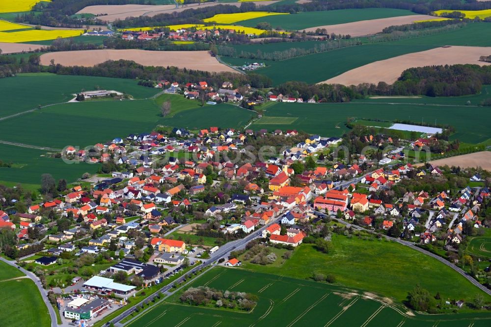 Hochkirch from above - Agricultural land and field boundaries surround the settlement area of the village along Karl-Marx-Strasse in Hochkirch in the state Saxony, Germany