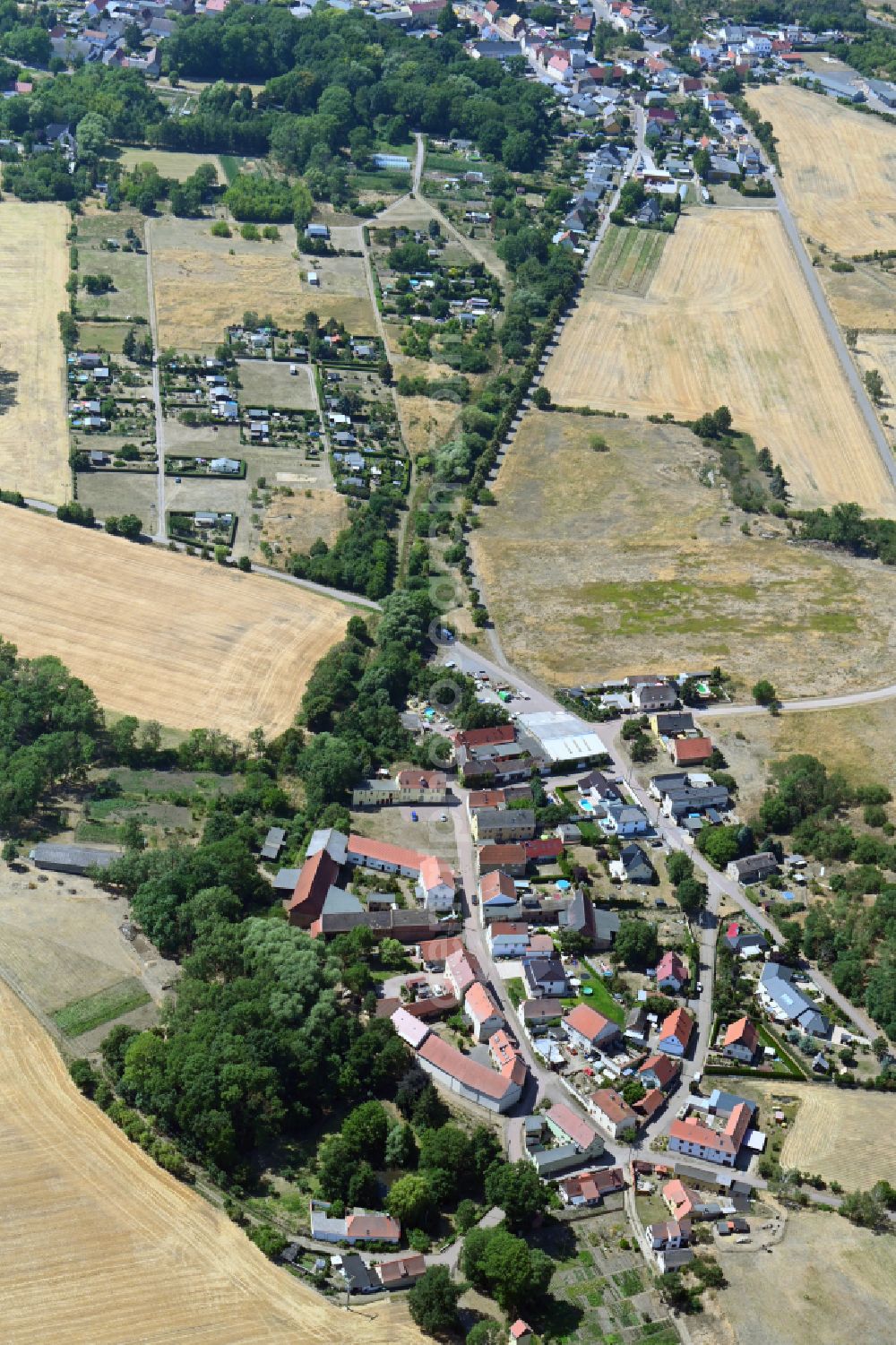 Hohen from above - Agricultural land and field boundaries surround the settlement area of the village in Hohen in the state Saxony-Anhalt, Germany