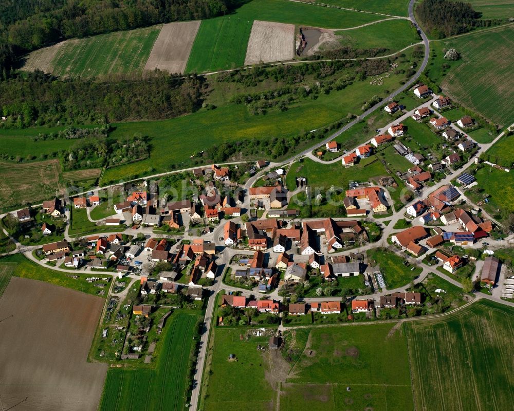 Hohenberg from above - Agricultural land and field boundaries surround the settlement area of the village in Hohenberg in the state Bavaria, Germany