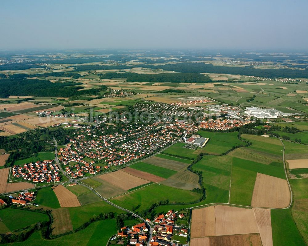 Hohenberg from above - Agricultural land and field boundaries surround the settlement area of the village in Hohenberg in the state Bavaria, Germany