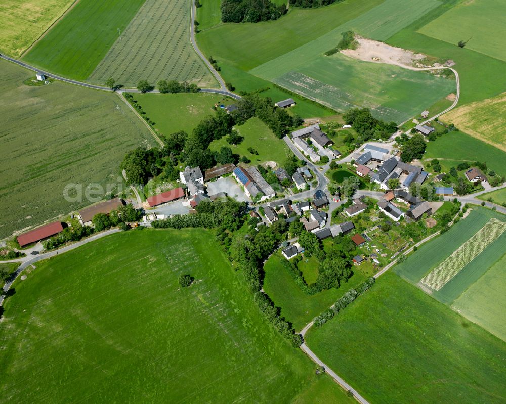 Hohendorf from above - Agricultural land and field boundaries surround the settlement area of the village in Hohendorf in the state Bavaria, Germany