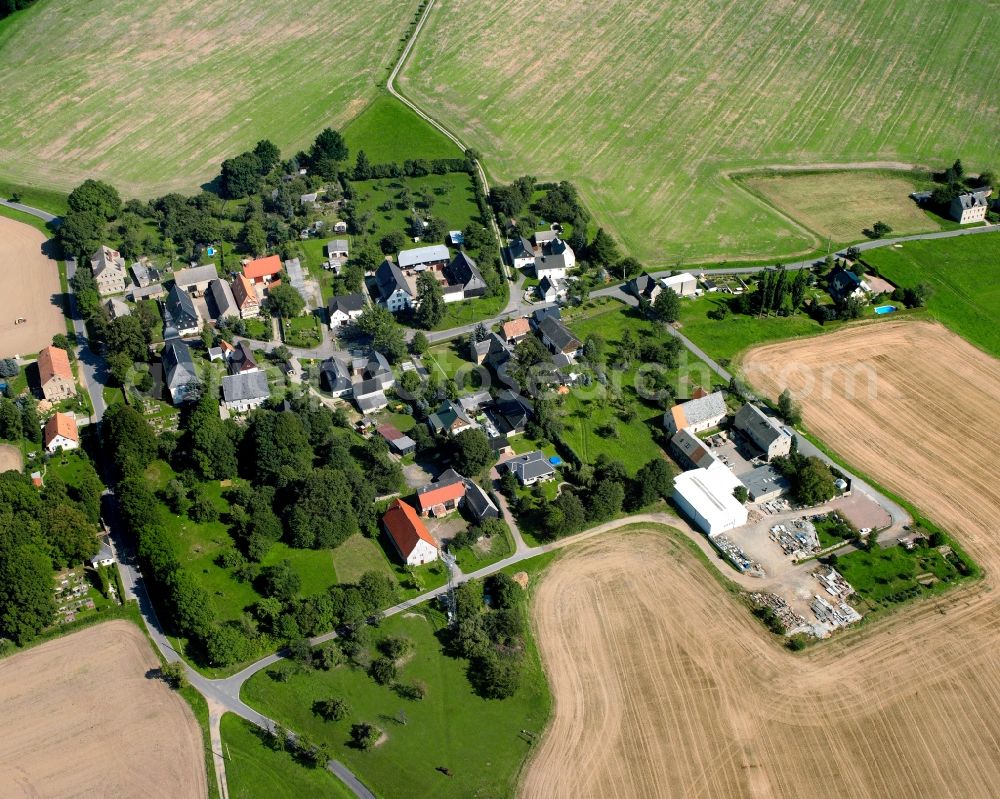 Hohenkirchen from above - Agricultural land and field boundaries surround the settlement area of the village in Hohenkirchen in the state Saxony, Germany