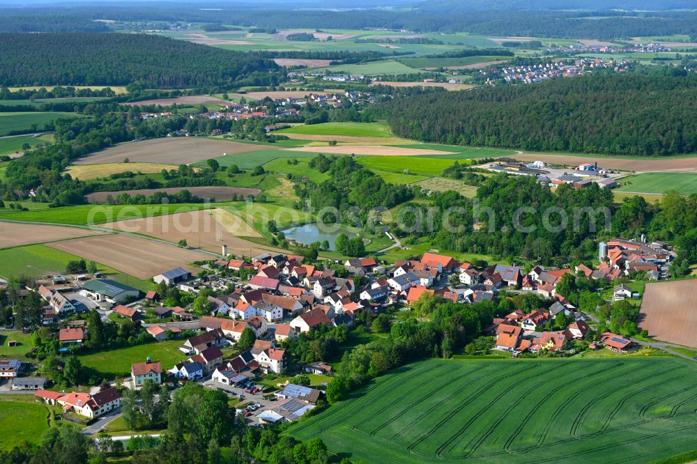 Hohnhausen from above - Agricultural land and field boundaries surround the settlement area of the village in Hohnhausen in the state Bavaria, Germany