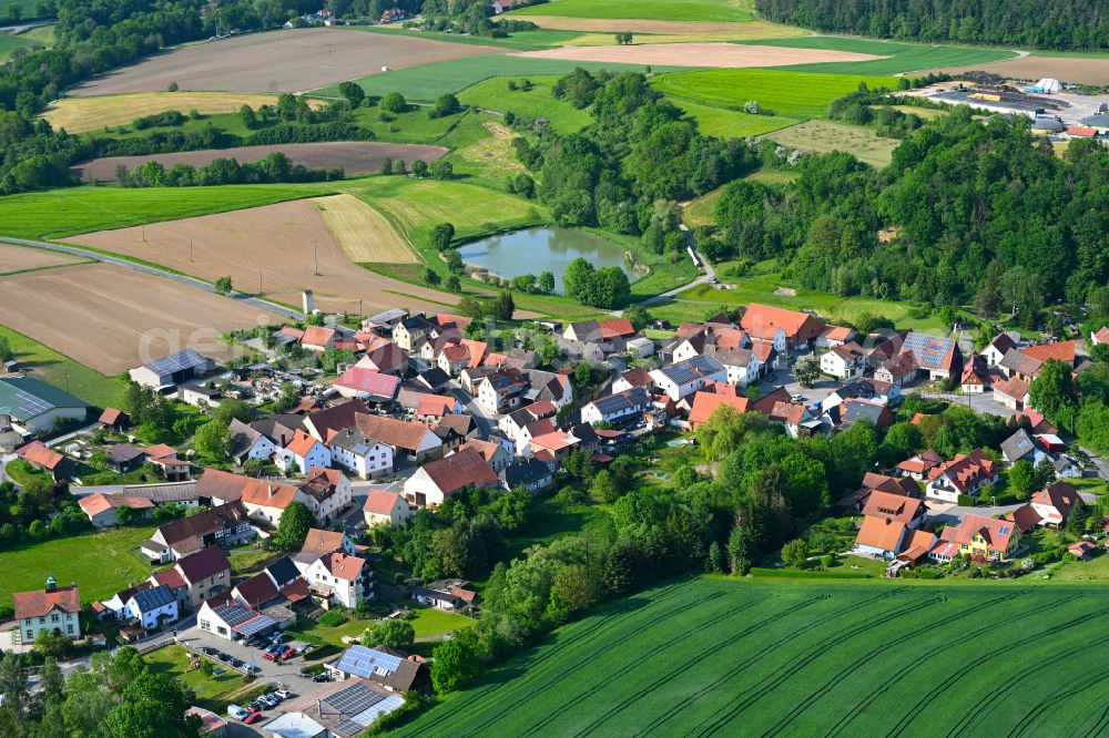 Hohnhausen from the bird's eye view: Agricultural land and field boundaries surround the settlement area of the village in Hohnhausen in the state Bavaria, Germany