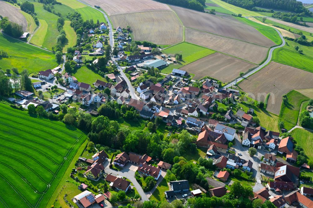 Hohnhausen from above - Agricultural land and field boundaries surround the settlement area of the village in Hohnhausen in the state Bavaria, Germany