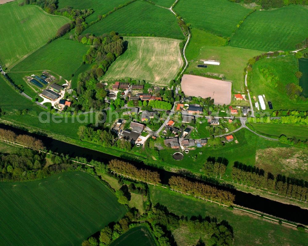 Aerial photograph Hollenbek - Agricultural land and field boundaries surround the settlement area of the village in Hollenbek in the state Schleswig-Holstein, Germany