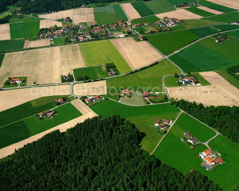 Holzen from above - Agricultural land and field boundaries surround the settlement area of the village in Holzen in the state Bavaria, Germany