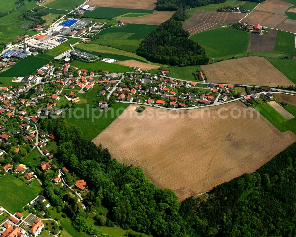 Holzham from above - Agricultural land and field boundaries surround the settlement area of the village in Holzham in the state Bavaria, Germany